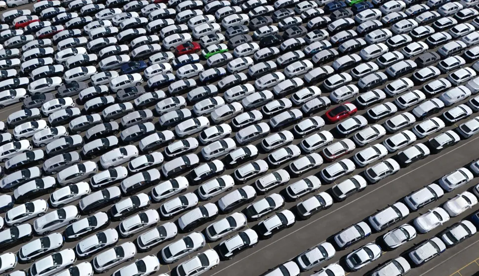 (FILES) An aerial view shows new cars of German car maker Volkswagen group ready for shipping next to the Volkswagen plant in Emden, northwestern Germany on May 20, 2025. India and the European Union announced on January 27, 2026 the "mother of all deals", a huge trade pact to create a market of two billion people, reached after two decades of negotiations. (Photo by Ina FASSBENDER/AFP)