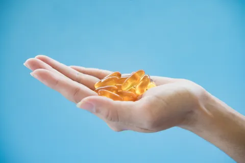 Woman's hand pours the medicine pills out of the bottle