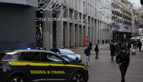 A car of the Italian Guardia di Finanza patrols in San Babila?s square ahead of Milano Cortina 2026 Olympic Games, in Milan on January 27, 2026. (Photo by MARCO BERTORELLO/AFP)