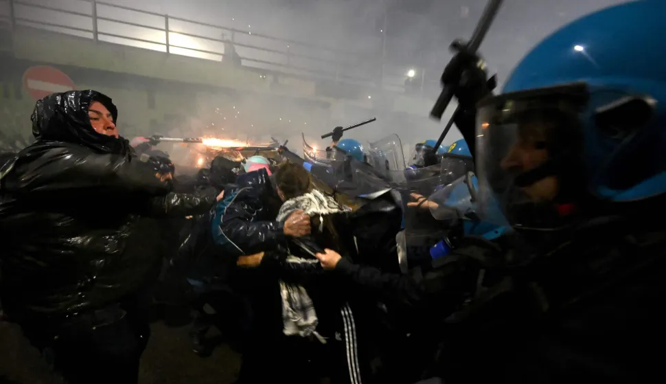 TOPSHOT - Demonstrators use fireworks against police officers during a protest against the environmental, economic and social impact of the Milano-Cortina 2026 Winter Olympics Games, in Milan on February 7, 2026. (Photo by PIERO CRUCIATTI/AFP)