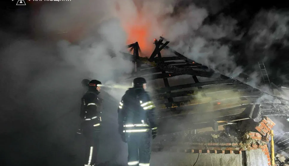 This handout photograph taken and released by the State Emergency Service of Ukraine on February 11, 2026, shows firefighters working to extinguish a fire at a private house following a Russian drone attack in Bogodukhiv Kharkiv region, amid the Russian invasion of Ukraine. A Russian drone strike on the Ukrainian city of Bogodukhiv killed three children and their father, an official said on Wednesday. A woman, identified by prosecutors as the children's mother who is eight months pregnant, was injured in the blast and sustained "a traumatic brain injury, acoustic barotrauma, and thermal burns", prosecutors said. (Photo by Handout/Ukrainian State Emergency Service/AFP)/XGTY/RESTRICTED TO EDITORIAL USE - MANDATORY CREDIT "AFP PHOTO/Ukrainian State Emergency Service" - NO MARKETING NO ADVERTISING CAMPAIGNS - DISTRIBUTED AS A SERVICE TO CLIENTS
