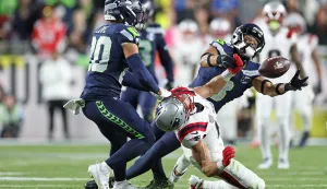 SANTA CLARA, CALIFORNIA - FEBRUARY 08: Julian Love #20 and Coby Bryant #8 of the Seattle Seahawks break up a pass intended for Mack Hollins #13 of the New England Patriots during Super Bowl LX at Levi's Stadium on February 08, 2026 in Santa Clara, California. Ronald Martinez/Getty Images/AFP (Photo by RONALD MARTINEZ/GETTY IMAGES NORTH AMERICA/Getty Images via AFP)