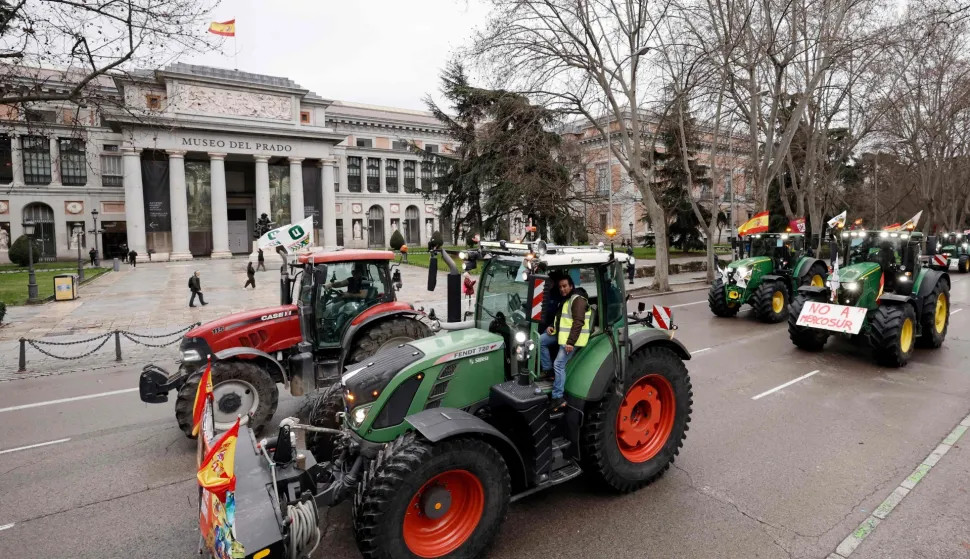 Spanish farmers protest with tractors against EU-Mercosur trade deal and the economic pressures facing the agricultural sector, in front of the Prado Museum in Madrid on February 11, 2026. Spain on January 9, 2026 celebrated the approval by EU nations of a vast trade deal with South American bloc Mercosur, championed by business groups but loathed by many European farmers. (Photo by Oscar DEL POZO/AFP)