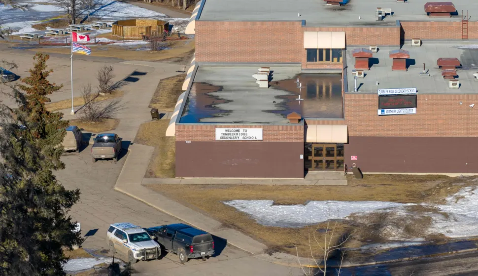 TOPSHOT - Aerial view of the middle school and high school building where a shooting took place, leaving at least nine people dead in the small town of Tumbler Ridge, British Columbia, on February 11, 2026. Canada was in mourning Wednesday, Prime Minister Mark Carney said, after a lone shooter killed at least nine people, including seven at a school, and injured dozens more in a remote western town. (Photo by Eagle Vision Agency/AFP)