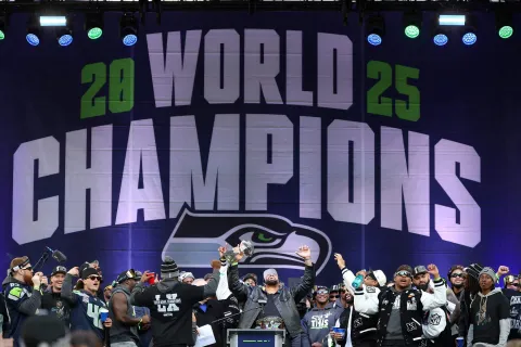 SEATTLE, WASHINGTON - FEBRUARY 11: Leonard Williams #99 of the Seattle Seahawks raises the Lombardi Trophy during the Seattle Seahawks Super Bowl LX victory celebration and parade at Lumen Field on February 11, 2026 in Seattle, Washington. Steph Chambers/Getty Images/AFP (Photo by Steph Chambers/GETTY IMAGES NORTH AMERICA/Getty Images via AFP)
