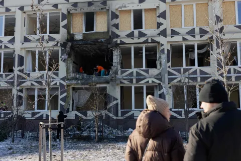 People clear debris in a damaged private medical clinic following a drone strike in Kyiv, on January 5, 2026, amid the Russian invasion in Ukraine. (Photo by Tetiana DZHAFAROVA/AFP)