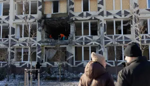 People clear debris in a damaged private medical clinic following a drone strike in Kyiv, on January 5, 2026, amid the Russian invasion in Ukraine. (Photo by Tetiana DZHAFAROVA/AFP)
