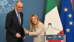 Italy's Prime Minister Giorgia Meloni and Germany's Chancellor Friedrich Merz share a joke at the end of a press conference after attending an Intergovernmental summit between Italy and Germany, at Villa Doria Pamphilj in Rome on January 23, 2026. (Photo by Andreas SOLARO/AFP)