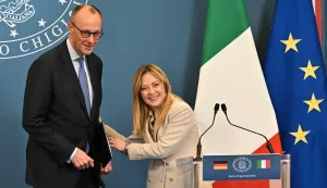 Italy's Prime Minister Giorgia Meloni and Germany's Chancellor Friedrich Merz share a joke at the end of a press conference after attending an Intergovernmental summit between Italy and Germany, at Villa Doria Pamphilj in Rome on January 23, 2026. (Photo by Andreas SOLARO/AFP)