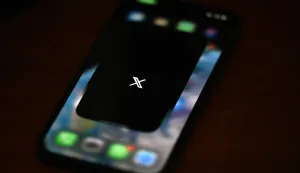 (FILES) This photo illustration shows the social media platform X (former Twitter) app on a smartphone in Rio de Janeiro, Brazil on September 18, 2024. Brazilian authorities reported on February 11, 2026, that they had ordered social media platform X to take immediate measures to prevent the creation of sexual images generated by Grok, its artificial intelligence (AI) assistant. (Photo by Mauro PIMENTEL/AFP)