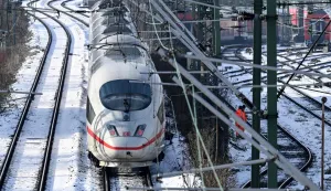 ICE high speed train drives on the snow-covered lines outside main railway station in Frankfurt am Main, western Germany, on January 27, 2026 as the air temperature reached 3 degrees Celsius above zero. (Photo by Kirill KUDRYAVTSEV/AFP)