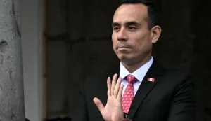 (FILES) Peru's President Jose Jeri (L) wavesafter watching the changing of the guard with Ecuador's President Daniel Noboa (out of frame) at Carondelet palace in Quito, on December 12, 2025. The Peruvian Congress impeached Jeri on February 17, 2026. The country's seventh head of state in 10 years, was accused of the irregular hiring of several women in his government, and a motion to oust him on claims of influence peddling received the backing of dozens of lawmakers. (Photo by Rodrigo BUENDIA/AFP)