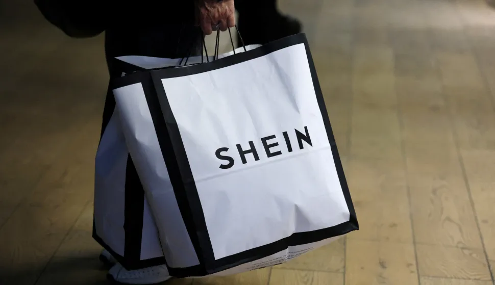FILE PHOTO: A customer holds shopping bags with a Shein logo in Paris, France, November 5, 2025. REUTERS/Sarah Meyssonnier/File Photo Photo: Sarah Meyssonnier/REUTERS