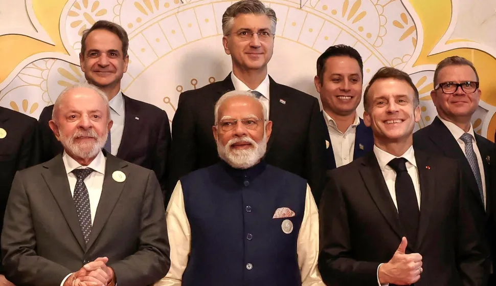 India's Prime Minister Narendra Modi (C), Brazil's President Luiz Inacio Lula da Silva (centre L) and France's President Emmanuel Macron (centre R) pose with other world leaders and representatives for a group photo during the AI Impact Summit in New Delhi on February 19, 2026. (Photo by Stephane LEMOUTON/POOL/AFP)