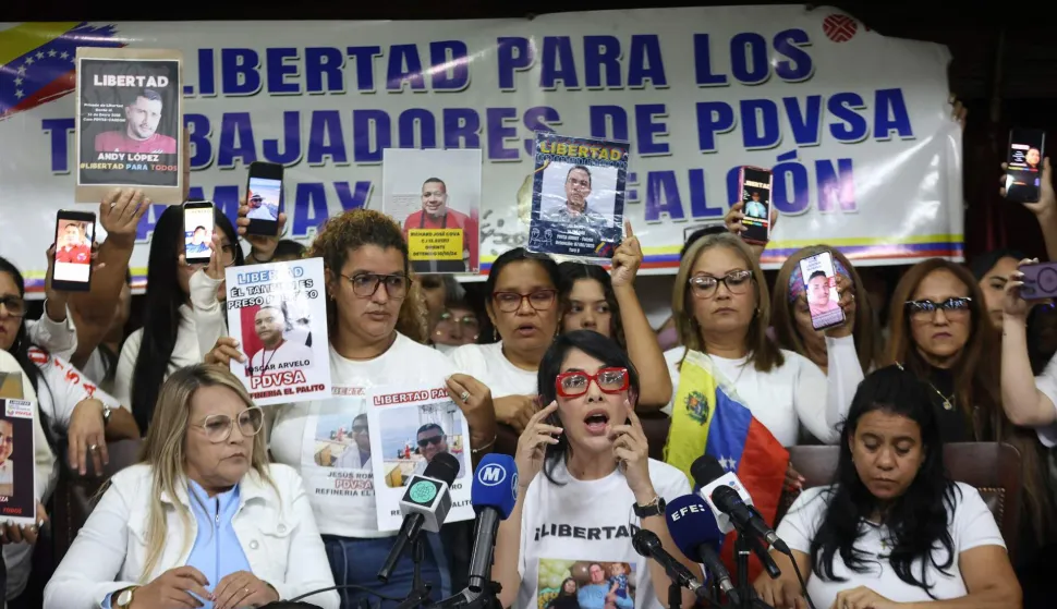 Lawyer Zimaru Fuentes (C) speaks accompanied by relatives and legal representatives of oil workers detained in Venezuela during a press conference in Caracas on February 18, 2026. (Photo by Pedro MATTEY/AFP)