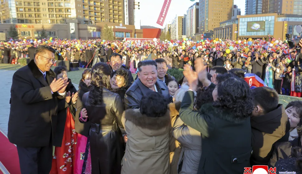 This picture taken on February 16, 2026 and released by North Korea's official Korean Central News Agency (KCNA) on February 17, 2026 shows North Korean leader Kim Jong Un (C) congratulating residents moving into their new homes at the inauguration ceremony of 10,000 flats at fourth stage in Hwasong area of Pyongyang. (Photo by KCNA VIA KNS/AFP)/South Korea OUT/---EDITORS NOTE--- RESTRICTED TO EDITORIAL USE - MANDATORY CREDIT "AFP PHOTO/KCNA VIA KNS" - NO MARKETING NO ADVERTISING CAMPAIGNS - DISTRIBUTED AS A SERVICE TO CLIENTSTHIS PICTURE WAS MADE AVAILABLE BY A THIRD PARTY. AFP CAN NOT INDEPENDENTLY VERIFY THE AUTHENTICITY, LOCATION, DATE AND CONTENT OF THIS IMAGE./