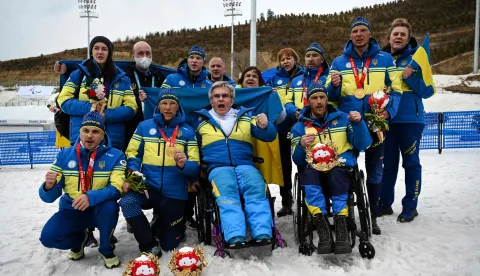 (FILES) Members of Team Ukraine gather around President of the Ukraine National Paralympic Committee Valerii Sushkevych, as they deliver a message to the press after the relay para cross-country skiing events, at The Zhangjiakou National Biathlon Centre on March 13, 2022, during the Beijing 2022 Winter Paralympic Games. The President of the Ukrainian Paralympic Committee told AFP that he feels the International Paralympic Committee (IPC) have betrayed Ukraine by permitting Russian athletes to compete under their own flag at the Milan-Cortina Games. (Photo by Lillian SUWANRUMPHA/AFP)