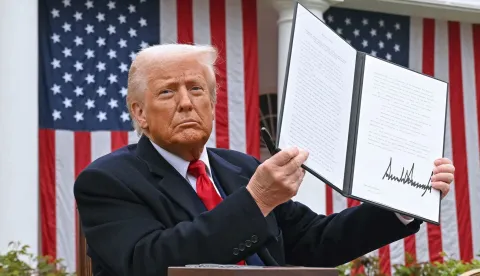 (FILES) US President Donald Trump holds a signed executive order after delivering remarks on reciprocal tariffs during an event in the Rose Garden entitled "Make America Wealthy Again" at the White House in Washington, DC, on April 2, 2025. The US Supreme Court ruled on February 20, 2026 that Donald Trump exceeded his authority in imposing a swath of tariffs that upended global trade, blocking a key tool the president has wielded to impose his economic agenda. (Photo by SAUL LOEB/AFP)
