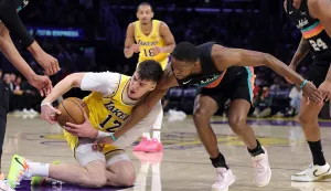 LOS ANGELES, CALIFORNIA - FEBRUARY 10: Jake LaRavia #12 of the Los Angeles Lakers gets the loose ball in front of De'aaron Fox #4 of the San Antonio Spurs in the first half at Crypto.com Arena on February 10, 2026 in Los Angeles, California. NOTE TO USER: User expressly acknowledges and agrees that, by downloading and or using this photograph, User is consenting to the terms and conditions of the Getty Images License Agreement. Ronald Martinez/Getty Images/AFP (Photo by RONALD MARTINEZ/GETTY IMAGES NORTH AMERICA/Getty Images via AFP)