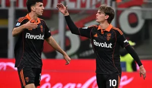 Como's Argentine midfielder #10 Nicolas Paz (R) celebrates with Como's Spanish defender #14 Jacobo Ramon (L) after scoring his team's first goal during the Italian Serie A football match between AC Milan and Como at the San Siro Stadium in Milan, northern Italy, on February 18, 2026. (Photo by Piero CRUCIATTI/AFP)