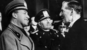 FILE - This is a January 14, 1939 file photo showing Italian Prime Minister Benito Mussolini. standing between Italian Foreign Minster Count Galeazzo Ciano and British Prime Minister Sir Neville Chamberlain, right, at the Termini railway station in Rome.  A historian says Benito Mussolini was well paid as a British agent during World War I. The Guardian newspaper reported Wednesday Oct. 14, 2009 that Peter Martland of Cambridge University discovered that Mussolini was paid 100 pounds a week by Britain in 1917 equal to about 6,000 pounds (US,600) today. (AP Photo, File, File)