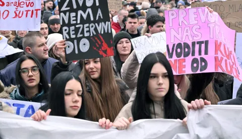 Protesters hold banners and placards during a rally after Erdoan Moranjkic has been killed in a deadly streetcar accident, in Sarajevo on February 21, 2026. Several thousand people marched in Sarajevo on on February 21, 2026 to demand ?justice? after a recent tram accident in the Bosnian capital in which a student was killed and a high school girl seriously injured, an AFP photographer reported. The accident fueled anger among young people, students, and high schoolers, who began gathering the next day, initially to express their solidarity and demand a swift investigation. (Photo by ELVIS BARUKCIC/AFP)