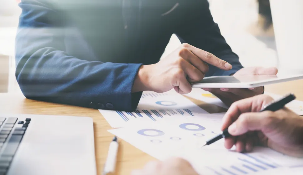 Businessman hand pointing at business document during discussion at meeting. Business analysis meeting training team.