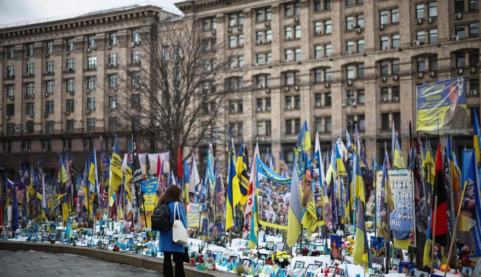 A local resident visits a makeshift memorial for Ukrainian and foreign soldiers in Independence Square in Kyiv on February 24, 2026, on the fourth anniversary of Russia?s invasion of Ukraine. (Photo by HENRY NICHOLLS/AFP)