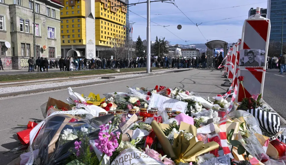 This photograph shows flowers displayed in homage to late student Erdoan Moranjkic killed in a deadly streetcar accident, in Sarajevo on February 18, 2026. High-school students and several associations of citizens, called for protest, after a public tram killed a 21 year old passenger and severely injured a 17 year old female who was standing at a tram station. (Photo by ELVIS BARUKCIC/AFP)