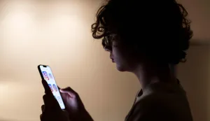 Teenager Bruno scrolls through social media on his phone in Madrid on February 4, 2026. Spain will seek to ban social media for under-16s to protect them from harmful content such as pornography and violence, Prime Minister Pedro Sanchez said yesterday, drawing a furious response from X owner Elon Musk. Telegram founder Pavel Durov today joined fellow tech tycoon Elon Musk in slamming Spanish Prime Minister Pedro Sanchez over his "dangerous" plan to ban social media for under-16s. (Photo by Paul Hanna/AFP)