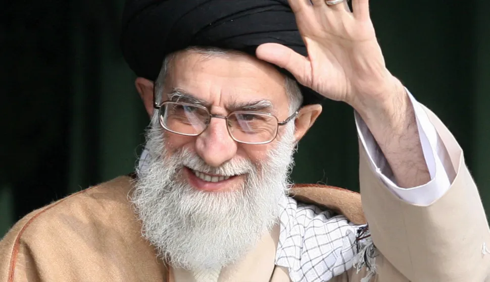 TOPSHOT - (FILES) Iranian supreme leader Ayatollah Ali Khamenei waves as he attends a gathering of Basij militia forces in Tehran on November 26, 2007. Witnesses said on February 28, 2026, that loud cheers echoed across parts of Tehran and residents took to their windows to applaud and play celebratory music after reports of Iranian supreme leader Ayatollah Ali Khamenei's death. (Photo by ISNA/AFP)