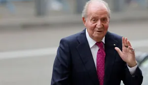 (FILES) Spain's former King Juan Carlos I salutes as he arrives at the wedding of Madrid's Mayor Jose Luis Martinez Almeida (not seen), at Sagrado Corazon y San Francisco de Borja church in Madrid on April 6, 2024. Could former King Juan Carlos, who has been in exile in Abu Dhabi since 2020, return to live in Spain? The debate was revived after the declassification of the archives on the failed putsch of 1981, documents that made him a key figure in democracy, AFP reports on February 27, 2026. (Photo by OSCAR DEL POZO/AFP)