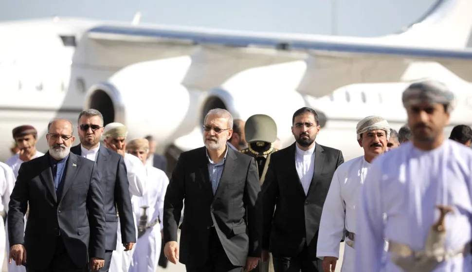 This photo released by Iran's Supreme National Security Council office shows Secretary of the Supreme National Security Council Ali Larijani (C) arriving in Muscat, Oman on February 10, 2026. Iran's top security official met Oman's ruler in Muscat on February 10, days after a new round of talks there between officials from Washington and Tehran. Ali Larijani, who heads the Supreme National Security Council, and Sultan Haitham bin Tariq "discussed the latest developments in the Iranian-American negotiations", the official Oman News Agency said. (Photo by HANDOUT/Iran's Supreme National Security/AFP)