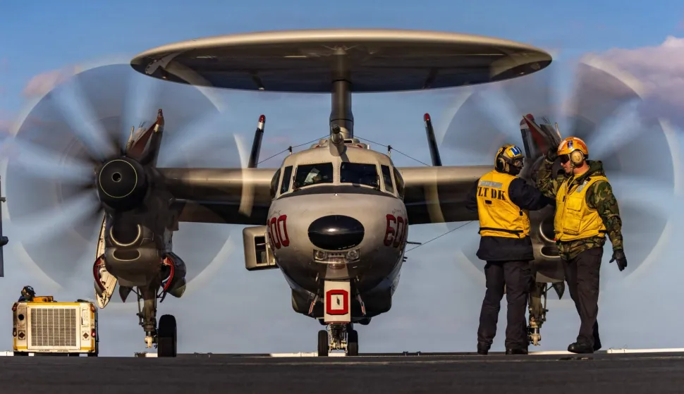 This US Navy photo released by US Central Command public affairs shows US Navy sailors signaling to an E-2D Hawkeye aircraft, attached to Airborne Command and Control Squadron 124, as it taxis on the flight deck of world's largest aircraft carrier, USS Gerald R. Ford (CVN 78), in support of Operation Epic Fury, from an undisclosed location on February 28, 2026. The United States and Israel launched a wave of strikes against targets in Iran on Saturday, sparking swift retaliation by the Islamic republic which responded with missile attacks across the region. (Photo by Sergeant First Class Michael Hunnisett/US Central Command (CENTCOM)/AFP)/RESTRICTED TO EDITORIAL USE - MANDATORY CREDIT "US CENTCOM/Sergeant First Class Michael Hunnisett/HANDOUT" - NO MARKETING NO ADVERTISING CAMPAIGNS - DISTRIBUTED AS A SERVICE TO CLIENTS