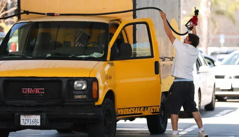 A driver pulls the gasoline pump hose to fill his truck tank at a gas station in the Marina Del Rey community of Los Angeles, California on March 2, 2026. Energy prices surged on March 2 as the war in the Middle East led to outages of key energy production operations. In parallel, energy markets are also absorbing a de facto halt to traffic in the Strait of Hormuz, through which about 20 percent of global supply of oil and liquid natural gas travel.The waterway has not technically been closed, but major maritime companies have suspended travel through it as insurance costs soar amid heightened risk. (Photo by Patrick T. Fallon/AFP)