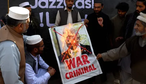 TOPSHOT - Activists and supporters of the Jamaat-e-Islami party burn a poster of US President Donald Trump during an anti-US and Israel protest in Peshawar on March 2, 2026 after the death of Iran's supreme leader Ayatollah Ali Khamenei amid US-Israel strikes. The death toll from Pakistan's violent weekend protests over the killing of Iran's supreme leader has reached at least 25, according to an AFP tally on March 2. (Photo by Abdul MAJEED/AFP)