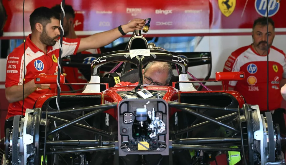 Mechanics work on Ferrari's British driver Lewis Hamilton's car ahead of the Formula One Australian Grand Prix at Albert Park in Melbourne on March 5, 2026. (Photo by Paul Crock/AFP)/-- IMAGE RESTRICTED TO EDITORIAL USE - STRICTLY NO COMMERCIAL USE --