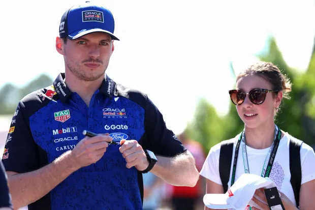 Red Bull Racing's Dutch driver Max Verstappen signs autographs for a fan ahead of the Formula One Australian Grand Prix at Melbourne?s Albert Park on March 5, 2026. (Photo by Martin KEEP/AFP)/-- IMAGE RESTRICTED TO EDITORIAL USE - STRICTLY NO COMMERCIAL USE --