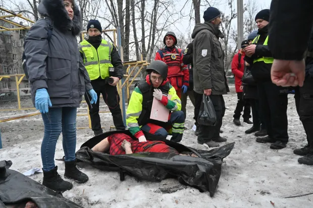 EDITORS NOTE: Graphic content/TOPSHOT - Police experts examine a body retrieved from under the rubbles of a five-story residential building which was hit by a ballistic missile in Kharkiv on March 7, 2026 amid the Russian invasion of Ukraine. Russia pummelled Ukraine with drone and missile attacks overnight, killing six people and triggering air alerts across the country, officials said. The bodies of five people were found in the rubble of an apartment block in the eastern Kharkiv region, while one person was killed in the Dnipropetrovsk region. (Photo by SERGEY BOBOK/AFP)