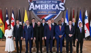 TOPSHOT - US President Donald Trump (C) stands with, (L/R), Trinidad and Tobago's Prime Minister Kamla Persad-Bissessar, Santiago Pe?a, President of the Republic of Paraguay, Luis Abinader, President of the Dominican Republic, Rodrigo Paz Pereira, President of Bolivia, Nayib Bukele, President of El Salvador, Javier Milei, President of Argentina, Jos? Ra?l Mulino, President of Panama, Mohamed Irfaan Ali, President of Guyana, Nasry ?Tito? Asfura, President of Honduras, Rodrigo Chaves Robles, President of Costa Rica, Jos? Antonio Kast, President-elect of Chile, and Daniel Roy Gilchrist Noboa Az?n, President of Ecuador, during a group photograph at the start of the "Shield of the Americas" Summit at Trump National Doral in Miami, Florida, March 7, 2026. President Trump is hosting a dozen right-wing leaders from Latin America and the Caribbean to discuss issues facing the region, from organized crime to illegal immigration. The summit also aims to serve Washington by boosting US interests in the region and curbing those from foreign powers like China. (Photo by SAUL LOEB/AFP)