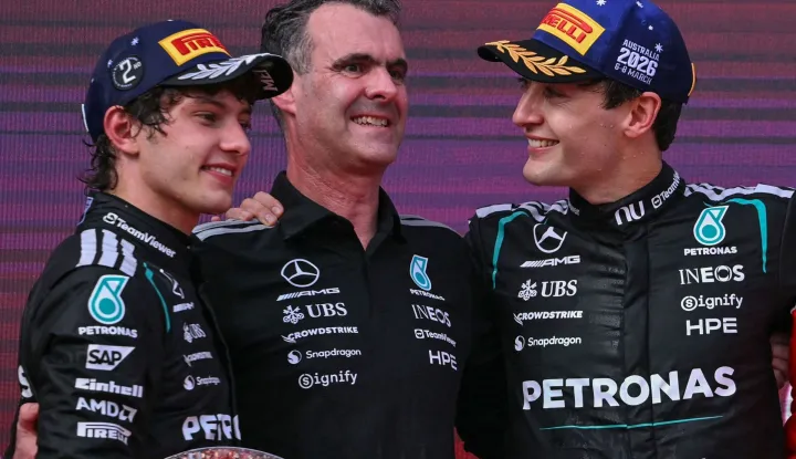 TOPSHOT - First-placed Mercedes' British driver George Russell (R) celebrates on the podium with second-placed Mercedes' Italian driver Kimi Antonelli (L) and Hywel Thomas (C), managing director of Mercedes AMG High Performance Powertrains, after the Formula One Australian Grand Prix at the Albert Park Circuit in Melbourne on March 8, 2026. (Photo by WILLIAM WEST/AFP)/-- IMAGE RESTRICTED TO EDITORIAL USE - STRICTLY NO COMMERCIAL USE --