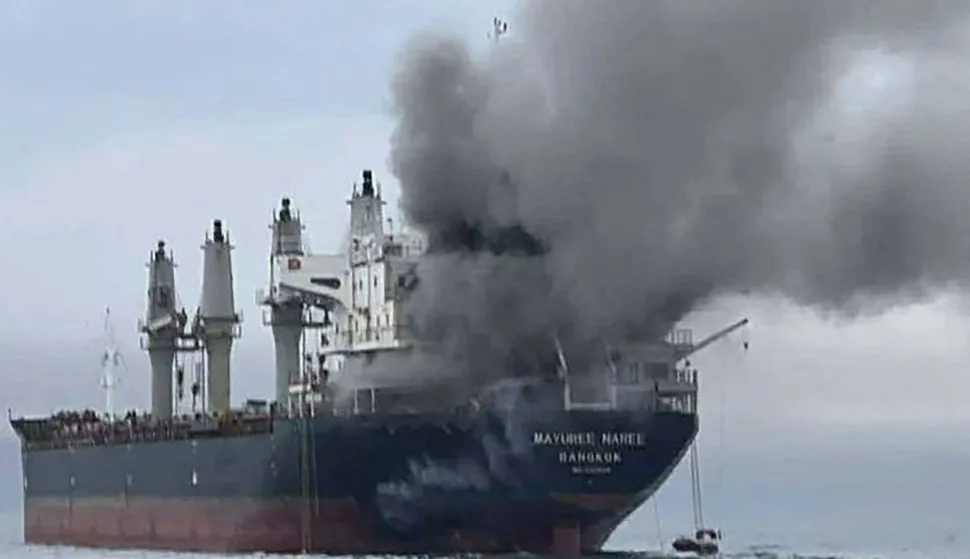 This handout photo taken on March 11, 2026 and released by the Royal Thai Navy shows smoke rising from the Thai bulk carrier 'Mayuree Naree' near the Strait of Hormuz after an attack. A Thai bulk carrier travelling in the crucial Strait of Hormuz was attacked March 11, with 20 crew members rescued so far, the Thai navy said. (Photo by Handout/ROYAL THAI NAVY/AFP)/-----EDITORS NOTE --- RESTRICTED TO EDITORIAL USE - MANDATORY CREDIT "AFP PHOTO/ROYAL THAI NAVY " - NO MARKETING - NO ADVERTISING CAMPAIGNS - DISTRIBUTED AS A SERVICE TO CLIENTS -