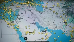 This photograph taken in Paris on March 1, 2026 shows a page on the Flightradar 24 website thats shows civilian flights avoiding Iranian and Iraqi sky. The biggest disruption to global air transport since the Covid pandemic continued on March 1, 2026, with thousands of flights affected and busy Middle Eastern hubs including Dubai and Doha shuttered as Iran lashed out after US-Israeli strikes. Iran, Iraq, Israel, Syria, Kuwait, Qatar and the United Arab Emirates had all announced at least partial closures of their skies Saturday after the US and Israel attacked Iran, bringing civilian air traffic over the Middle East to an abrupt halt. (Photo by Anna KURTH/AFP)