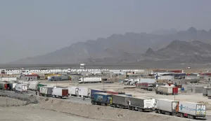 Cargo trucks wait to enter the Pakistan-Iran border crossing at Taftan, Balochistan province on March 2, 2026 amid ongoing US-Israel strikes on Iran. (Photo by Banaras KHAN/AFP)