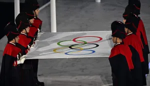 The Carabinieri carry the Olympic flag during the closing ceremony of the Milano Cortina 2026 Winter Olympic Games at the Verona Arena in Verona, northern Italy, on February 22, 2026. (Photo by Gabriel BOUYS/POOL/AFP)