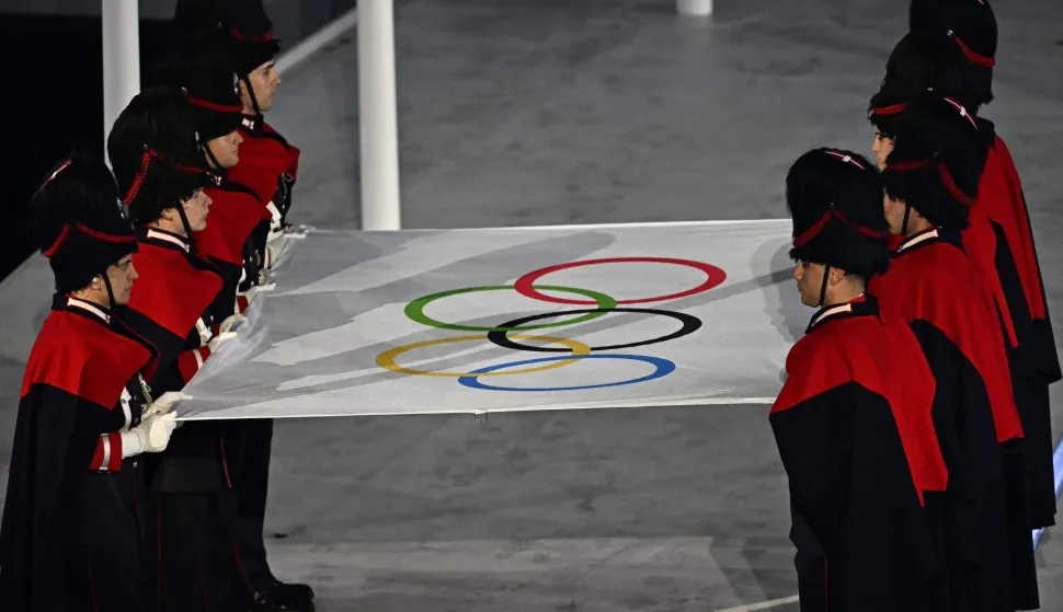 The Carabinieri carry the Olympic flag during the closing ceremony of the Milano Cortina 2026 Winter Olympic Games at the Verona Arena in Verona, northern Italy, on February 22, 2026. (Photo by Gabriel BOUYS/POOL/AFP)