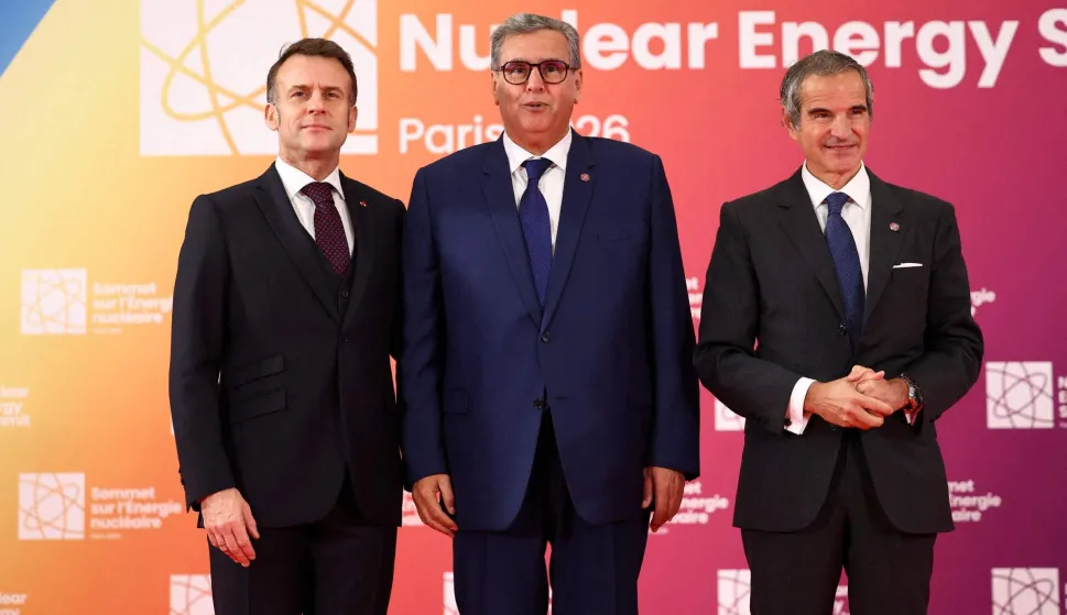 French President Emmanuel Macron (L) and Director General of the International Atomic Energy Agency (IAEA) Rafael Grossi (R) pose with Moroccan Prime Minister Aziz Akhannouch (C) upon arrival at the Nuclear Energy Summit at the Seine Musicale venue in Boulogne-Billancourt, outside Paris, on March 10, 2026. (Photo by Abdul Saboor/POOL/AFP)