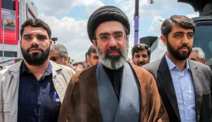 HAMENEI (FILES) In this picture obtained from Iran's ISNA news agency, Mojtaba Khamenei (C), son of Iran's supreme leader Ayatollah Ali Khamenei, walks along a street in Tehran on May 31, 2019. Iran marked the appointment of Ayatollah Mojtaba Khamenei to replace his father as its supreme leader with a new barrage of missiles against Israel and the Gulf states on March 9, 2026, as the Middle East war sent oil prices soaring. (Photo by Hamid FOROUTAN/ISNA/AFP)