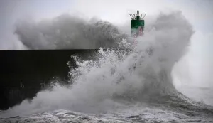 TOPSHOT - A big wave crashes against the pier at the port of A Guarda, northwestern Spain, on January 23, 2026. Depression Ingrid is expected to bring snow, torrential rain, and icy winds to Spain today as extreme weather and a sharp temperature drop are expected. (Photo by Miguel RIOPA/AFP)