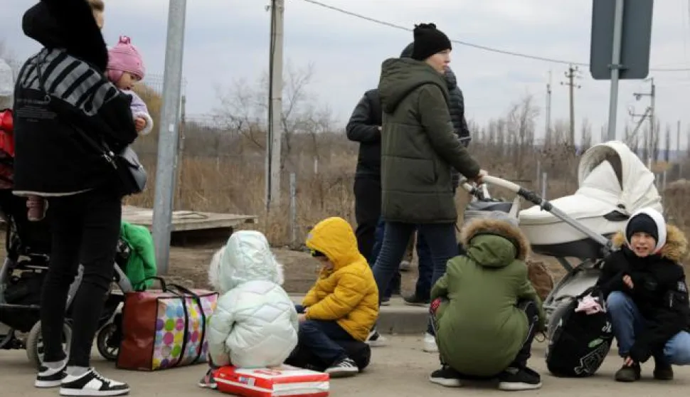 epa09821412 Ukrainian mothers and their children wait for a ride from family members in Moldova, upon their arrival at the border crossing between Ukraine and Moldova, at Palanca, Moldova, 13 March 2022. Refugees upon their entry to Moldova board a minibus to a nearby reception center where they receive a warm drink then embark on a trip to the capital Chisinau, Poland, or Germany. Seventeen days into the Russian invasion of Ukraine the numbers of refugees fleeing the conflict to neighboring countries continues to increase, according to the UNHCR. Moldova has until 13 March received about 299,573 refugees, some 198,897 left to other EU countries and 100,676 chose to stay. The same day, residents of the Ukrainian cities Nykolaiv, Odessa and areas nearby continue to stream into Moldova while a few others went back to Ukraine, either because they want to bring more personal items, to check on their property, or because they feel overwhelmed and want to return home in spite of the danger. EPA/AMEL PAIN